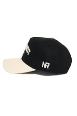 The WAKE FOREST Established Hat by No Rivals is a black cotton cap featuring a white brim, white NR embroidery on the left side, and an adjustable snap back for a comfortable fit.
