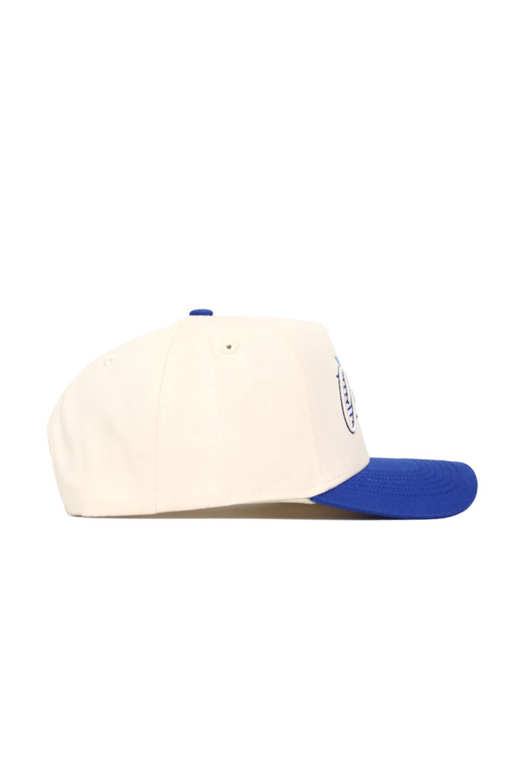 The No Rivals Creighton Triangle Game Cap Hat is shown in a side view, featuring a structured fit with a white crown and blue brim, set against a plain white background.