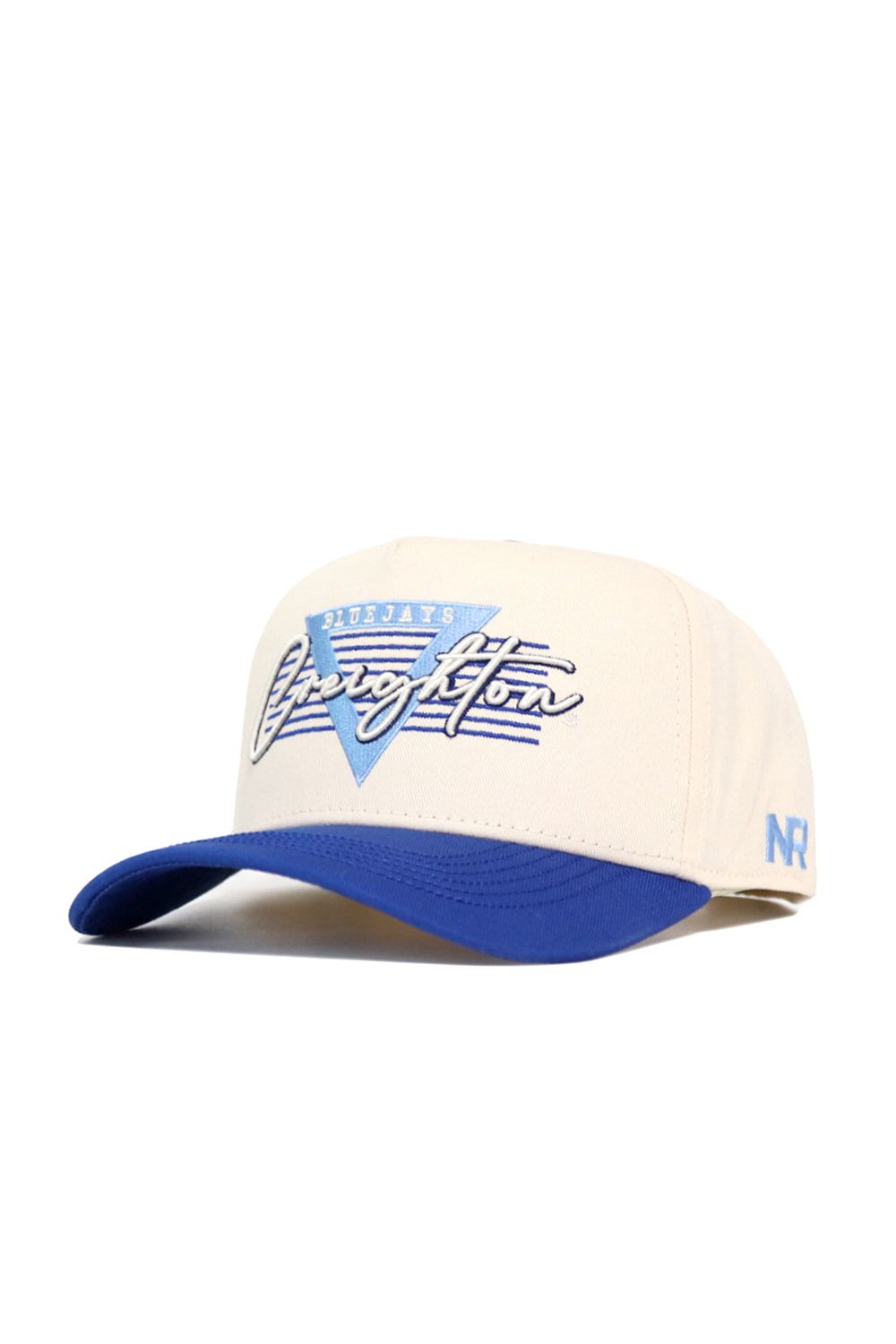The No Rivals Creighton Triangle Game Cap Hat is cream with a blue brim, embroidered Blue Jays Creighton text, a blue V on the front, and NR lettering on the side. This structured snapback is officially licensed for authentic style.
