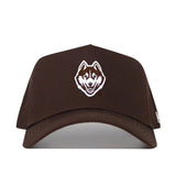 The UConn Americano Hat is a brown, structured snapback crafted from premium cotton, featuring a white and brown embroidered Husky dog face logo on the front.