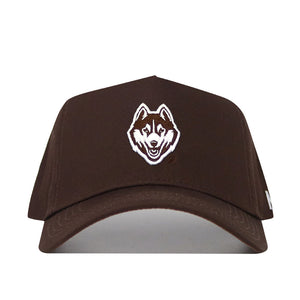 The UConn Americano Hat is a brown, structured snapback crafted from premium cotton, featuring a white and brown embroidered Husky dog face logo on the front.
