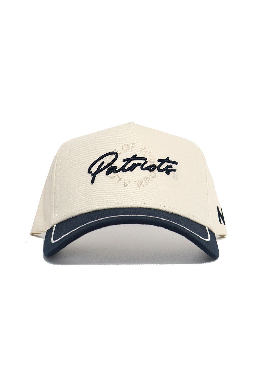 The No Rivals DBU Patriots ALOYO Hat is a cream snapback with "Patriots" in black script, a black visor with white trim, quality cotton structured fit, and a small black side detail.