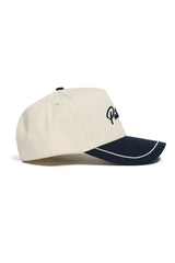 The No Rivals DBU Patriots ALOYO Hat is a beige baseball cap with a curved black brim, white trim, and black embroidered front text, made from high quality cotton in a structured fit, shown side view on a white background.