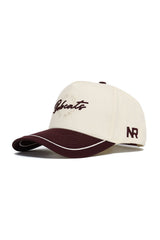 The Texas State Bobcats ALOYO Hat by No Rivals is a beige and maroon snapback cap with "Bobcats" on the front, "NR" initials on the side, a curved brim, and maroon and white accents. Made from high-quality cotton.