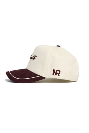 The Texas State Bobcats ALOYO Hat by No Rivals is a cream snapback with a maroon brim, script-style front embroidery, and maroon NR initials on the side. Made from premium cotton for comfort and durability.