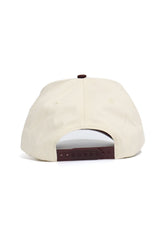 The Texas State Bobcats ALOYO Hat by No Rivals is a beige snapback shown from the back, featuring a brown adjustable strap, two small ventilation eyelets, and is made from high-quality cotton for lasting comfort.