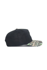 The No Rivals Mizzou Logo Camo Hat - Trailblazer Edition is a black cotton baseball cap with a green and brown camo curved visor, displayed in side profile on a white background.