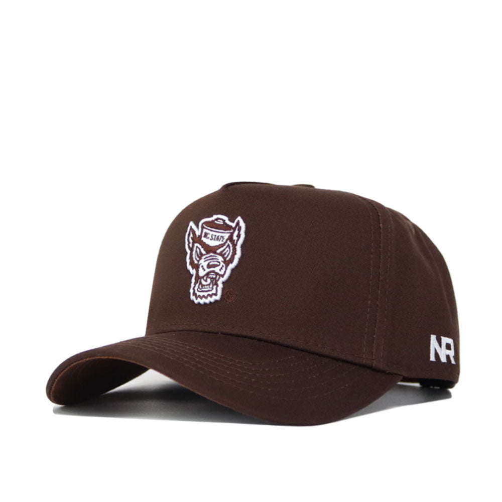 The NC State Americano Hat is a brown snapback made from high-quality cotton, featuring an embroidered wolf head logo on the front and white "NR" letters on the side.