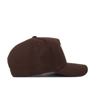 The Vanderbilt Americano Hat is a brown baseball cap shown in side profile on a white background, featuring high-quality cotton, a structured fit, curved brim, and visible stitching on its panels and brim.