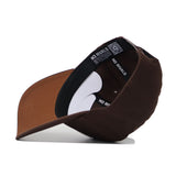The Vanderbilt Americano Hat is a brown snapback turned inside out, revealing its black sweatband with "NO RIVALS" in white and a visible QR code, showcasing the high-quality cotton and structured fit.