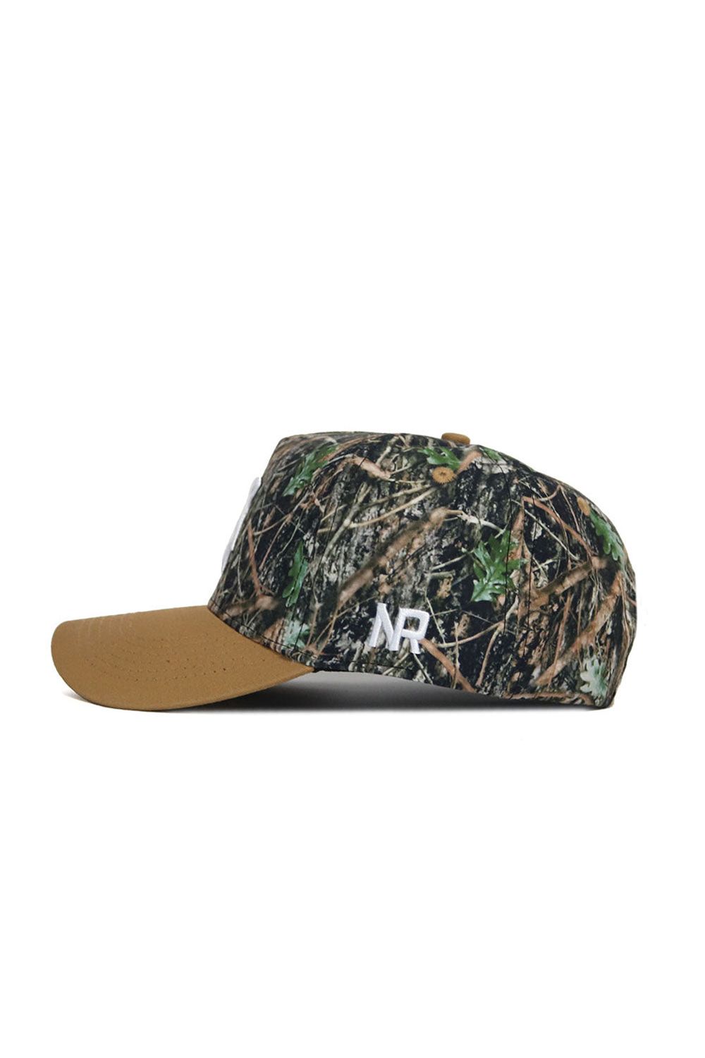 Side view of the Michigan State Camo Hat - Explorer Edition by No Rivals, featuring a brown suede bill, camouflage cotton crown, white "NR" side embroidery, and an adjustable snap back.