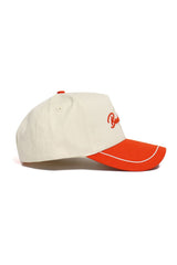 The SHSU Bearkats ALOYO Hat by No Rivals features a beige and red snapback design with a structured fit, red brim with white trim, side red embroidery, and a red top button. Shown in side profile, crafted from quality cotton.