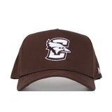 The Creighton Americano Hat is a brown snapback featuring a white logo, made from high-quality cotton for a structured fit.