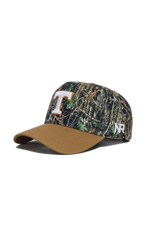 The Tennessee Camo Hat - Explorer Edition by No Rivals features a camo design with a brown bill, an orange and white T on the front, NR embroidery on the side, premium cotton construction, and a snapback closure for an adjustable fit.