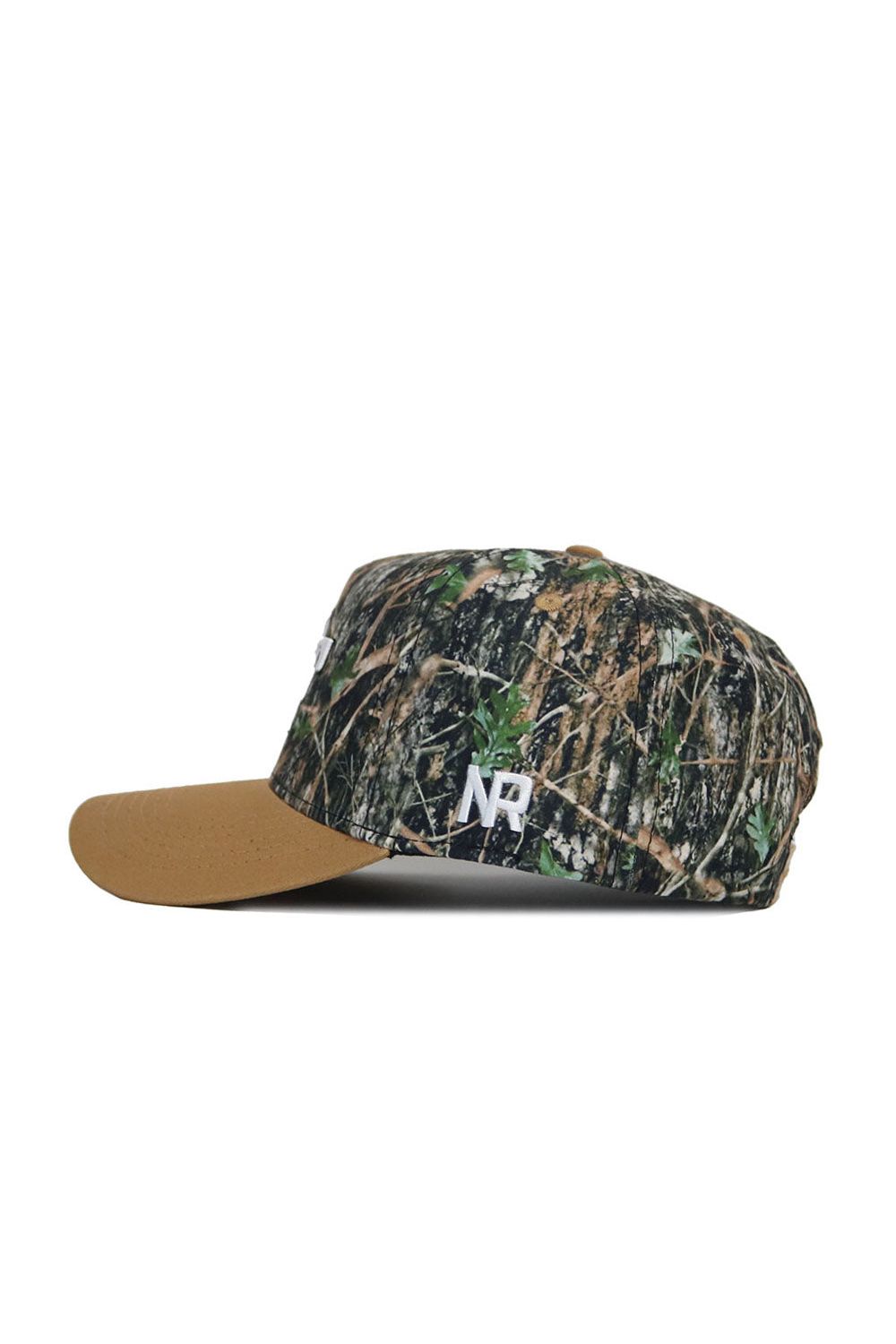 The Wake Forest Camo Hat - Explorer Edition by No Rivals is a structured snapback featuring a brown brim, camouflage crown, and white NP lettering embroidered on the side.