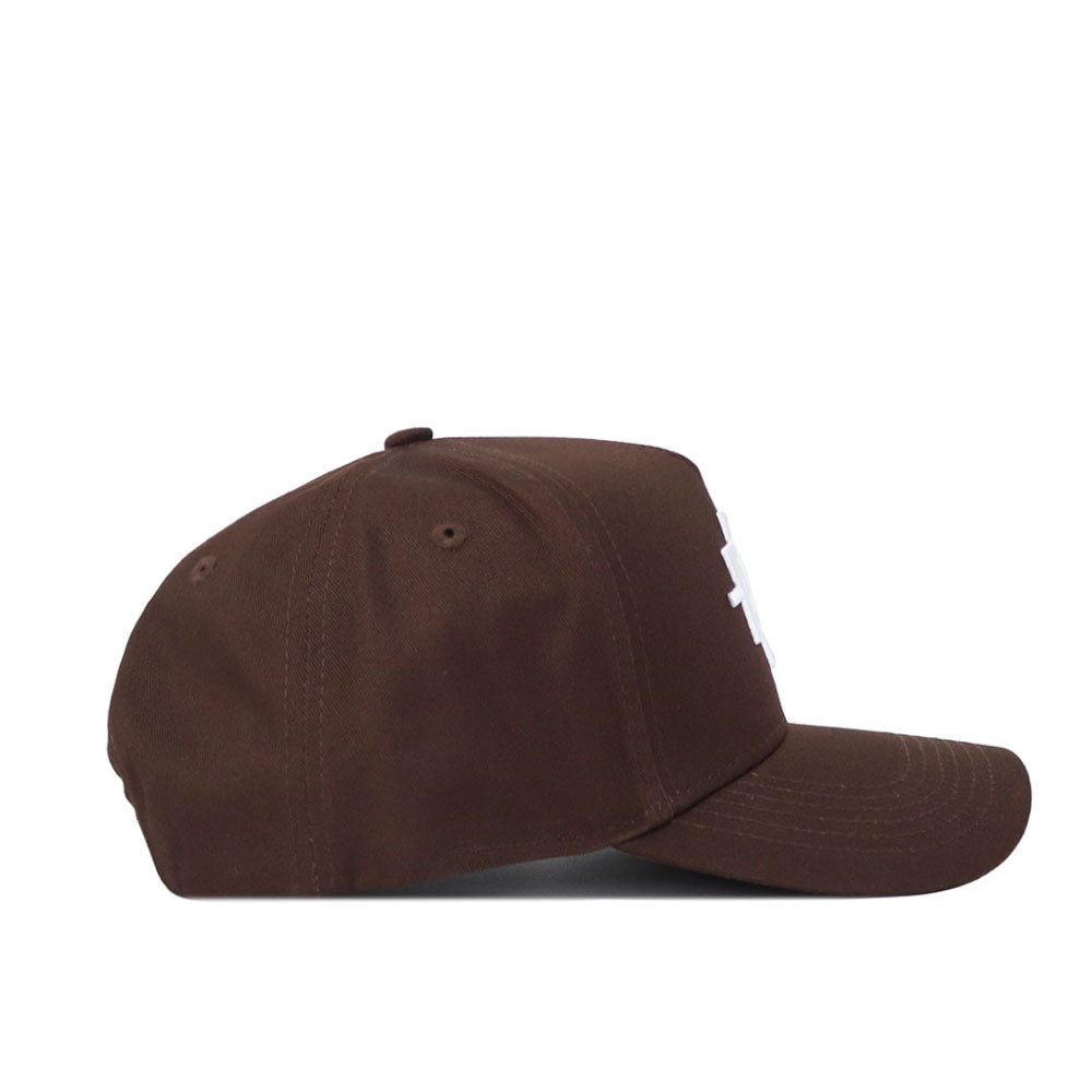 The San Diego State Americano Hat is a brown baseball cap with a structured fit, curved brim, white front design, visible stitching, top eyelets, and official licensing. Shown from the side.
