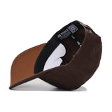 The BYU Americano Hat is a brown snapback with a white and black band, offering a structured fit for comfort and style.