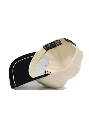 The Wake Forest ALOYO Hat by No Rivals is a cream-colored cap with a black underside brim, "NO RIVALS" on the inner band, high-quality cotton, and a snapback for comfort.