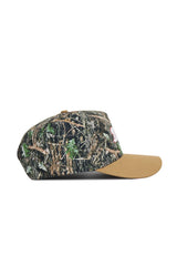 The No Rivals Dallas Camo Hat - Explorer Edition features a green and brown camo cotton crown with a solid tan brim, shown in side profile against a white background.