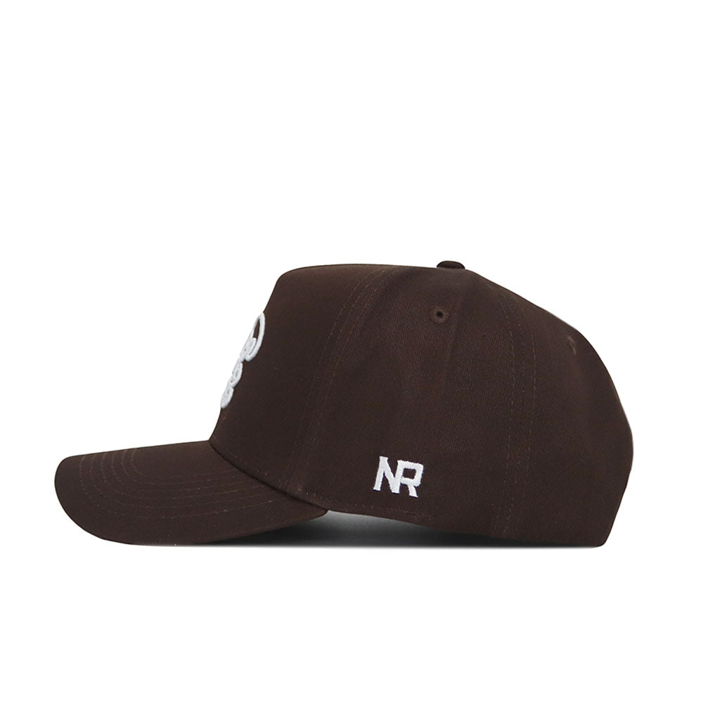 The Tulane Americano Hat is a brown baseball cap with a side view, featuring a small white NR logo embroidered near the back. Made from high-quality cotton, it has a curved brim, visible stitching, and a structured fit for lasting comfort.