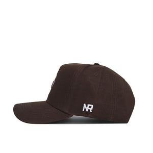 The University of Maryland Americano Hat is a dark brown baseball cap made from high quality cotton, shown in a side view with white embroidered NR letters near the back.