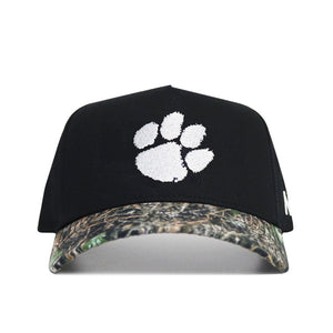 The No Rivals Clemson Camo Hat - Trailblazer Edition is a structured black cap with a white paw print logo and a camouflage-patterned brim, crafted from high quality cotton.