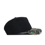 The No Rivals Clemson Camo Hat - Trailblazer Edition features a structured black snapback design, high-quality cotton build, and a camouflage-patterned brim, shown from the side on a white background.