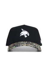 The No Rivals Texas State Camo Hat - Trailblazer Edition features a black cotton crown, white bobcat logo on the front, camouflage brim, and an adjustable snapback closure for comfort and style.
