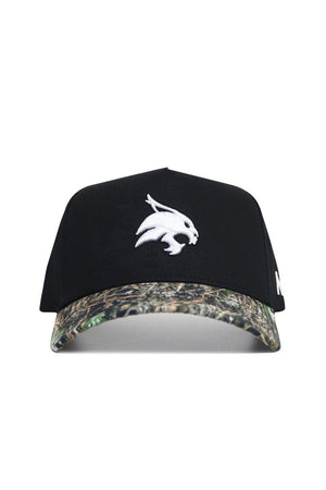 The No Rivals Texas State Camo Hat - Trailblazer Edition features a black cotton crown, white bobcat logo on the front, camouflage brim, and an adjustable snapback closure for comfort and style.