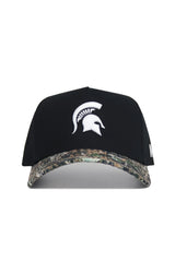 The No Rivals Michigan State Camo Hat - Trailblazer Edition is a black snapback with a white Spartan helmet logo and a camo-patterned brim, made from premium cotton for a structured fit.