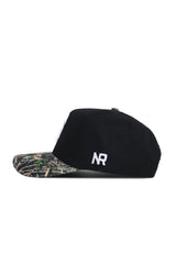 The Michigan State Camo Hat - Trailblazer Edition by No Rivals features a black structured fit, camouflage-patterned brim, and white NR initials stitched on the side, crafted from high-quality cotton and displayed in side profile on a white background.