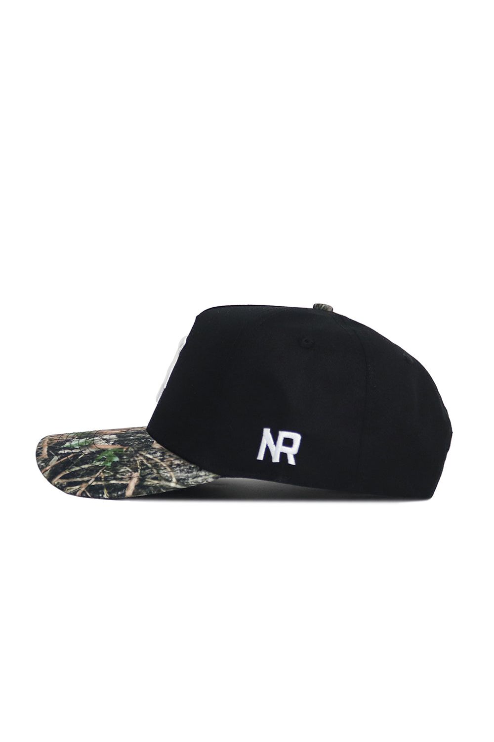 The Michigan State Camo Hat - Trailblazer Edition by No Rivals features a black structured fit, camouflage-patterned brim, and white NR initials stitched on the side, crafted from high-quality cotton and displayed in side profile on a white background.