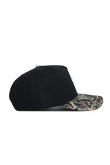 The No Rivals Michigan State Camo Hat - Trailblazer Edition features a structured fit with a solid black cotton crown and camouflage-patterned brim, displayed in side view against a white background.