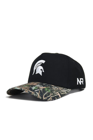 The Michigan State Camo Hat - Trailblazer Edition by No Rivals is a black snapback with a camo brim, featuring a white Spartan helmet front logo and NR on the side. Made from quality cotton for structured style and comfort.