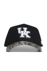 The No Rivals Kentucky Camo Hat - Trailblazer Edition is a high-quality cotton black baseball cap with a white UK logo on the front, a camo-patterned curved brim, and a structured fit design.