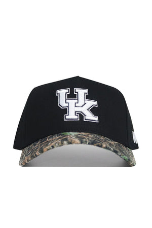 The No Rivals Kentucky Camo Hat - Trailblazer Edition is a high-quality cotton black baseball cap with a white UK logo on the front, a camo-patterned curved brim, and a structured fit design.
