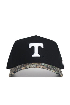 The No Rivals Tennessee Camo Hat - Trailblazer Edition is a black structured-fit baseball cap crafted from premium cotton, featuring a bold white "T" on the front and a camo-patterned brim.