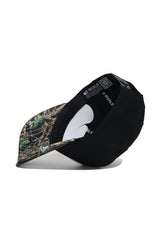 The Wake Forest Camo Hat - Trailblazer Edition by No Rivals is a black snapback with a camo-patterned brim, shown upside down to reveal its structured fit and "No Rivals" printed on the interior band.
