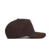 The Wyoming Americano Hat is a brown, high-quality cotton baseball cap with a curved brim and adjustable strap, shown from the side against a white background.