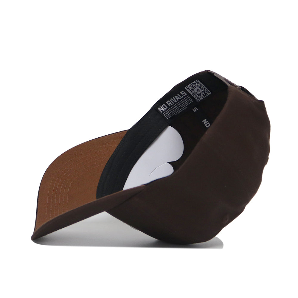 The Wyoming Americano Hat is pictured upside down, displaying its black inner band with white labels and a brown brim underside, all crafted from high quality cotton.