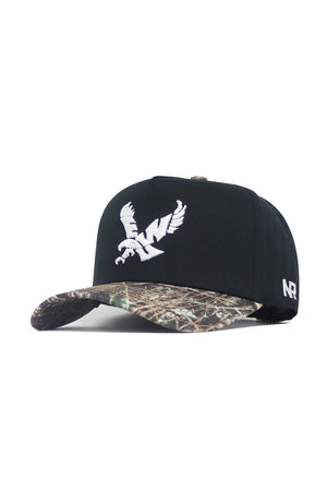 The No Rivals EWU Camo Hat - Trailblazer Edition is a structured fit snapback featuring a black crown, camo-patterned brim, white embroidered bird logo on the front, and NR initials on the side.