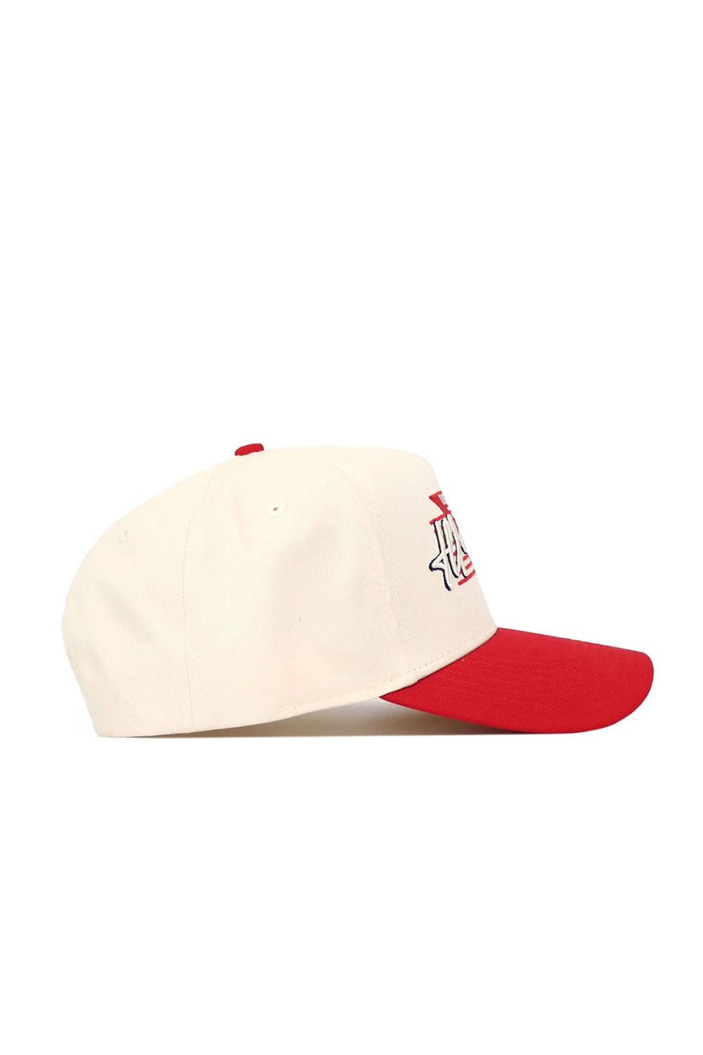 The No Rivals Illinois State University Triangle Game Cap Hat is cream-colored with a red brim and top button, viewed from the side. Made of high quality cotton, it displays part of a red and white logo on the front for a classic touch.