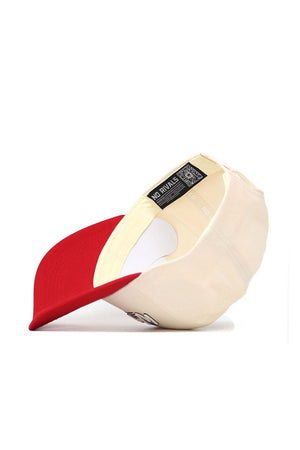 The Western Kentucky Triangle Game Cap Hat by No Rivals features a cream color, structured fit, and red brim. Shown upside down to reveal the NO RIVALS label in white on black inside the cap.