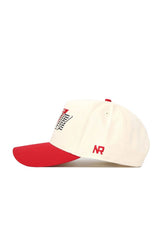 The No Rivals UNLV Triangle Game Cap Hat is cream-colored with a red bill and accents, featuring “NR” embroidered in red on the side, a black and red front graphic, and made from high-quality cotton for a structured fit.