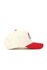 The No Rivals UNLV Triangle Game Cap Hat, a cream-colored cotton baseball cap with a red brim and a small side logo, is displayed in profile against a plain white background.