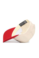 The Utah Triangle Game Cap Hat by No Rivals is a beige snapback with a red brim, shown upside down to reveal its "NO RIVALS" inner band, structured fit, and visible edge stitching.