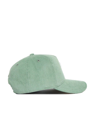 A side view of the No Rivals Tennessee Corduroy Hat in Spring Green, featuring a structured fit, curved brim, snapback closure, and ventilation eyelets.