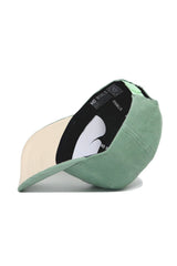 The Tennessee Corduroy Hat - Structured - Spring Green by No Rivals is shown upside down, displaying its beige underside and a black inner band featuring the brand's NO RIVALS white text.