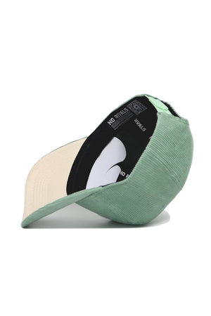 The Tennessee Corduroy Hat - Structured - Spring Green by No Rivals is shown upside down, displaying its beige underside and a black inner band featuring the brand's NO RIVALS white text.