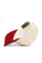 The Arkansas Triangle Game Cap Hat by No Rivals is displayed upside down, showing its red bill, cream crown, interior lining, and a “NO RIVALS” label. This snapback offers a structured fit for comfort and style.
